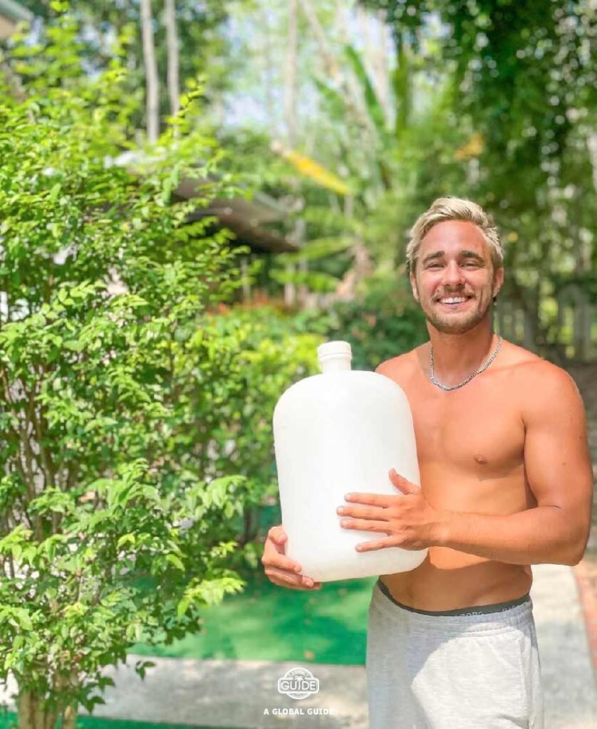 Man holding a 20l jug of water.