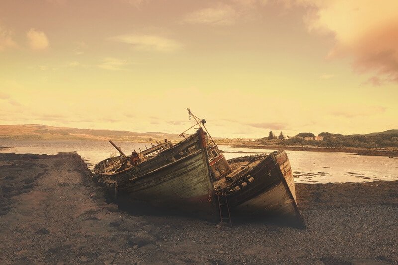 Two shipwrecks on a beach.